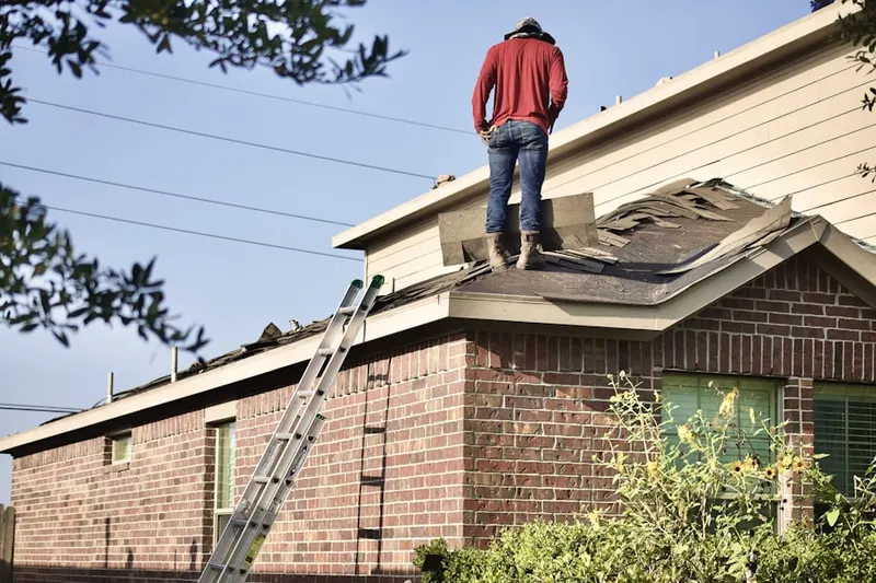 Professional roofer working on a residential roof in Wedgewood Forest